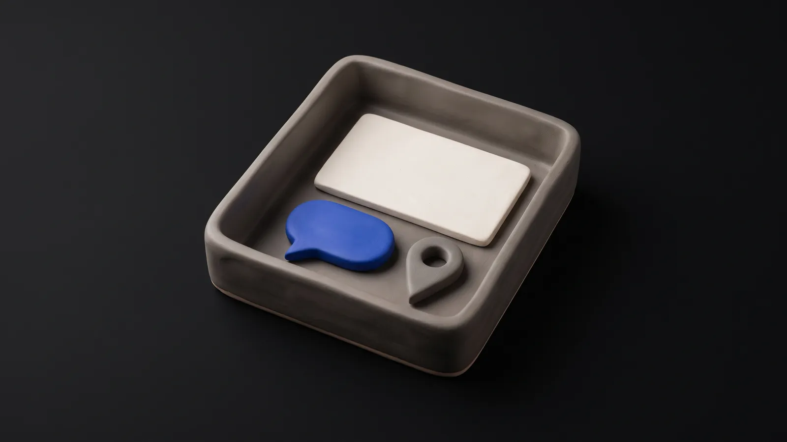 A matte clay speech bubble on a clay calendar block with one cobalt day marked, on a near-black background